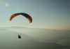 Experience the thrill of paragliding over the stunning Lake Annecy with breathtaking mountain views.